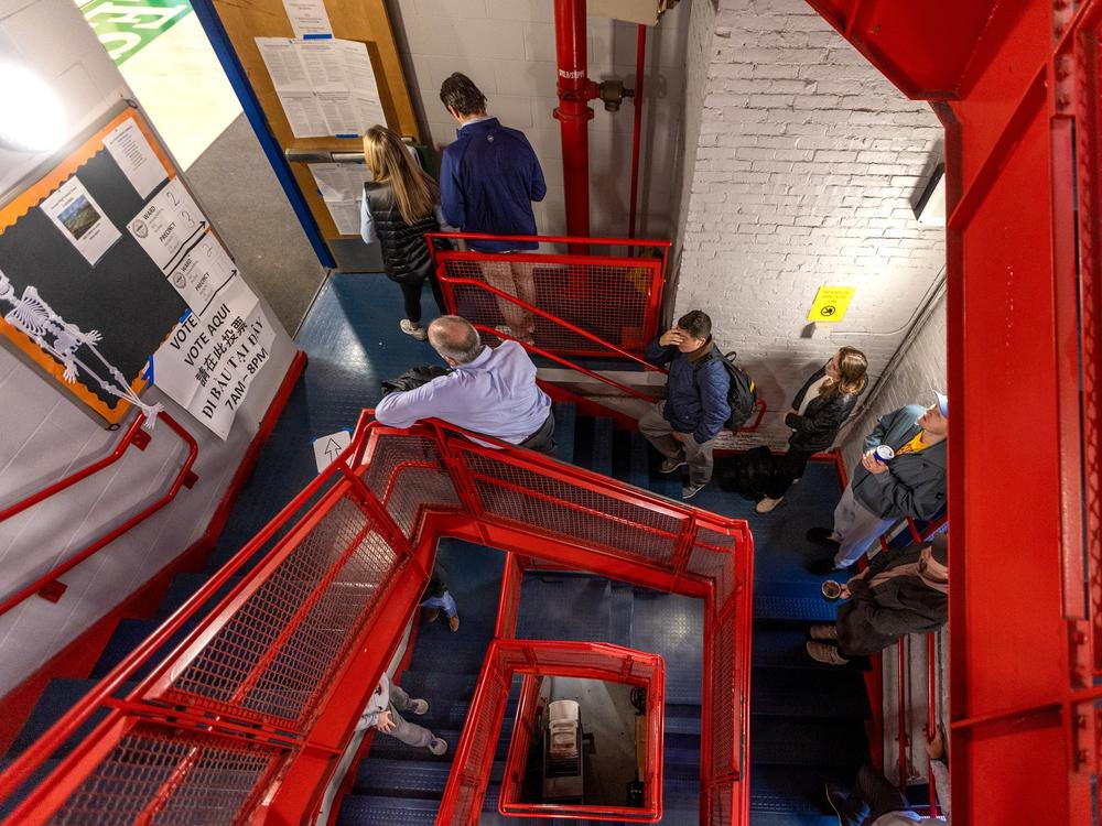 Voters wait in a long line down a spiral staircase before the polls open at 7 a.m. at the Charlestown Boys and Girls Club in Boston on Nov. 5. Full story <a href=
