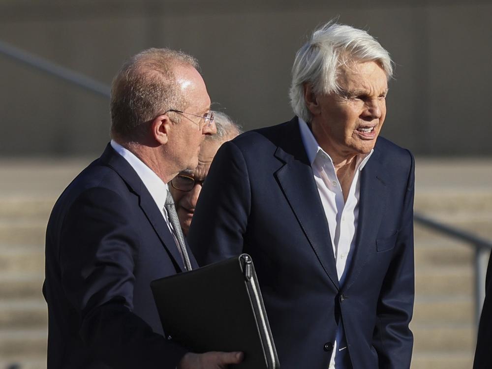 Michael Jeffries (right), former CEO of Abercrombie & Fitch, exits the federal courthouse after his arraignment on sex trafficking and interstate prostitution charges Oct. 25 in Central Islip, N.Y.