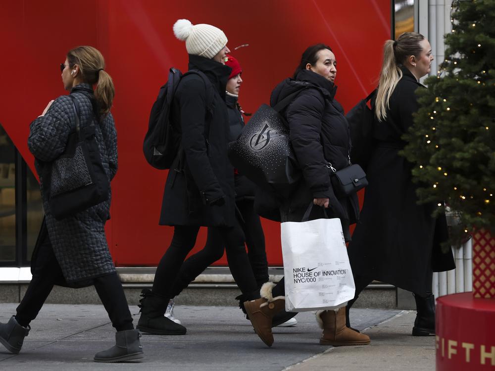 Shoppers walk along Fifth Avenue on Nov. 29 in New York City.