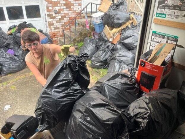 Tristen Williams helps remove clutter from the home of someone with hoarding disorder in Greensburg, Pennsylvania. The homeowner decided to ask for help with the cleanout after attending a course and support group offered by the nonprofit Fight the Blight, founded by Williams' father.<br>