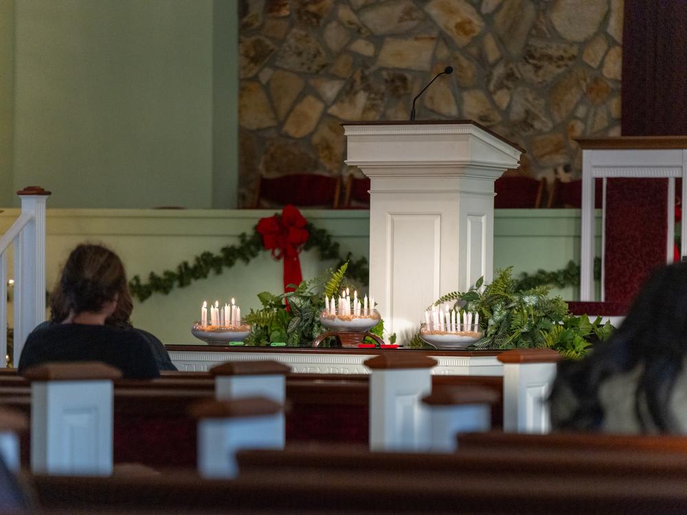 People gathered for a candlelight vigil at Marantha Baptist Church in Plains, Ga., on Monday. This was Jimmy Carter's church where he often preached and held Sunday school sermons.