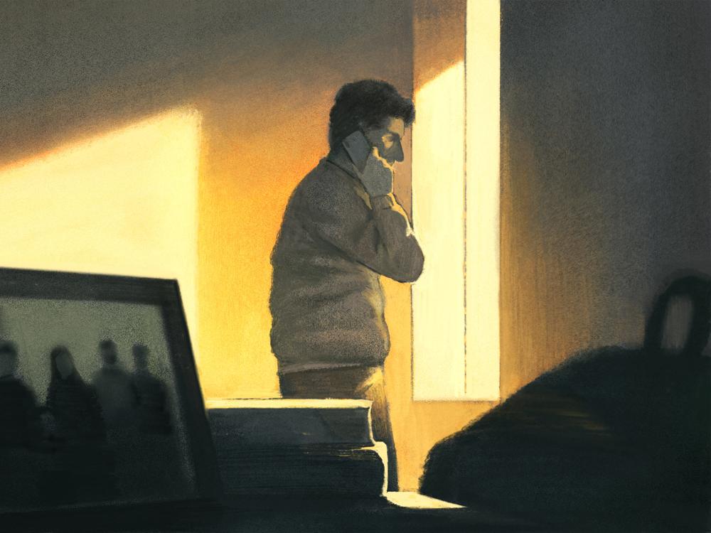 BH talking to his family through the phone in the background and photos of the family in the foreground.