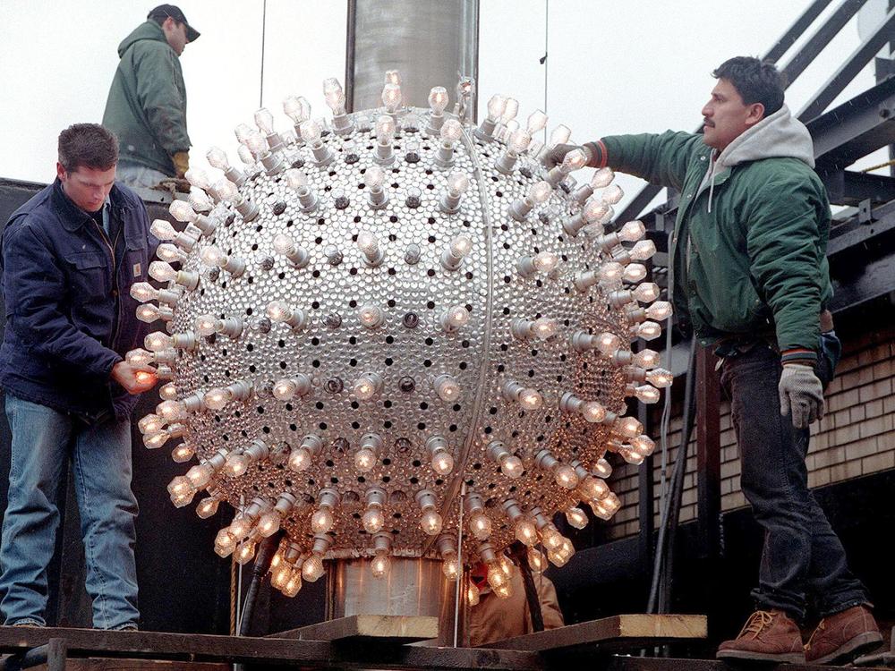 Workers prepare the 180 halogen lamps and 144 Xenon glitter strobes on the 500 pound Times Square New Year ball in 1997.