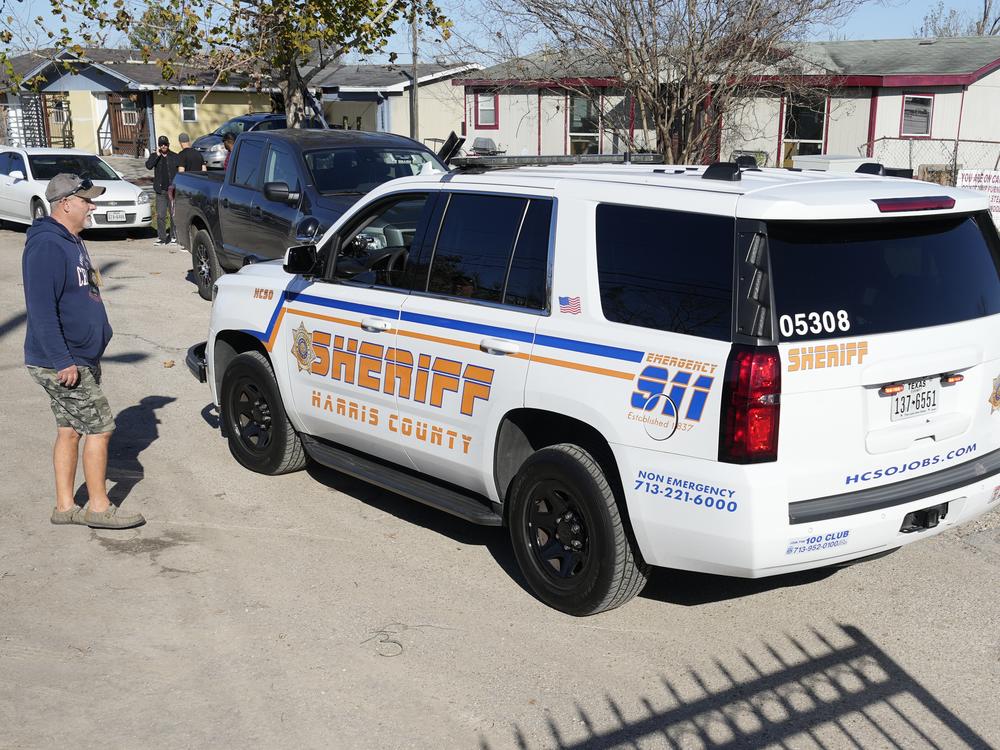 Harris County Sheriff's officers arrive in the neighborhood where Jabbar, the 42-year-old suspect, is believed to have lived in Houston.