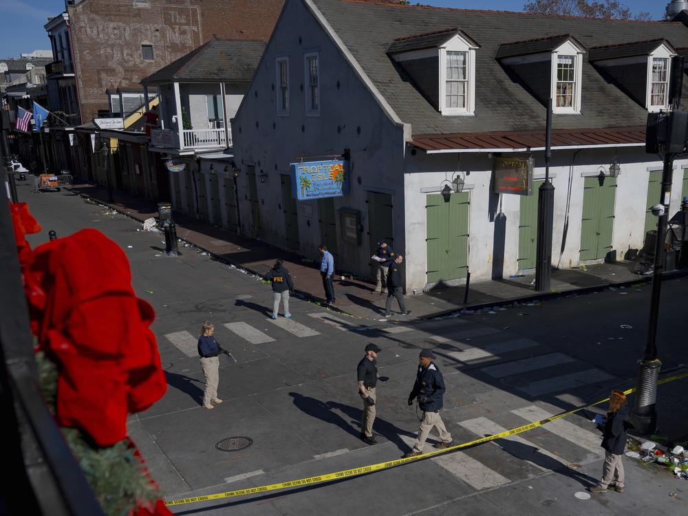 Members of the FBI walk around Bourbon Street during the investigation of a truck fatally crashing into pedestrians on Bourbon Street.