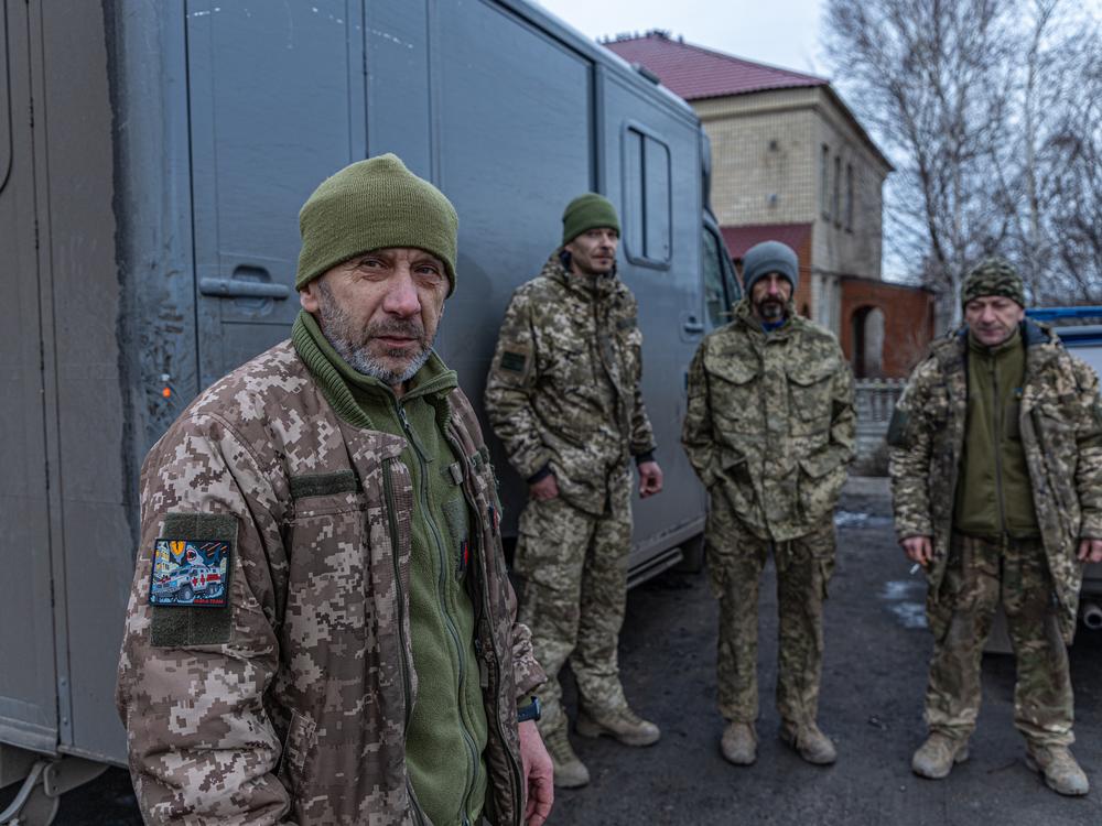 Serhii, 58, (left) is a driver, paramedic and commander of the medical unit 