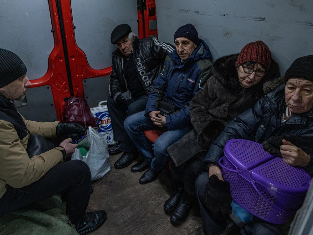Residents of Pokrovsk forced from their homes by Russian artillery and drone attacks huddle inside an armored minivan used to evacuate civilians.