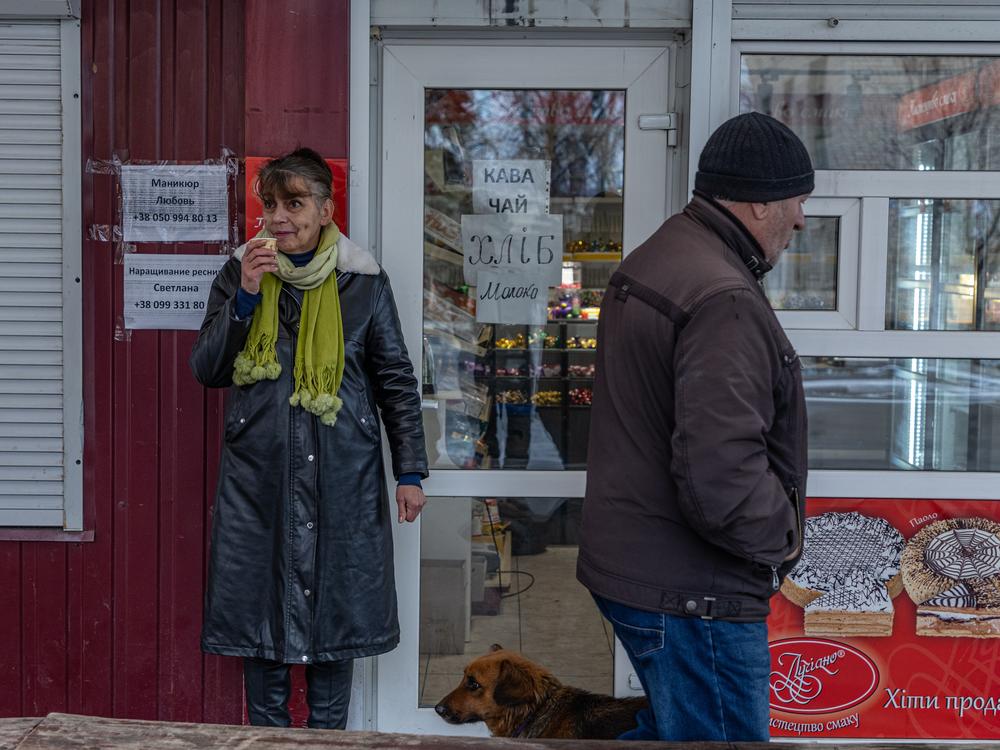 Svitlana Storozhko, owner of a small grocery, drinks coffee by the entrance of her shop in the center of Pokrovsk. 