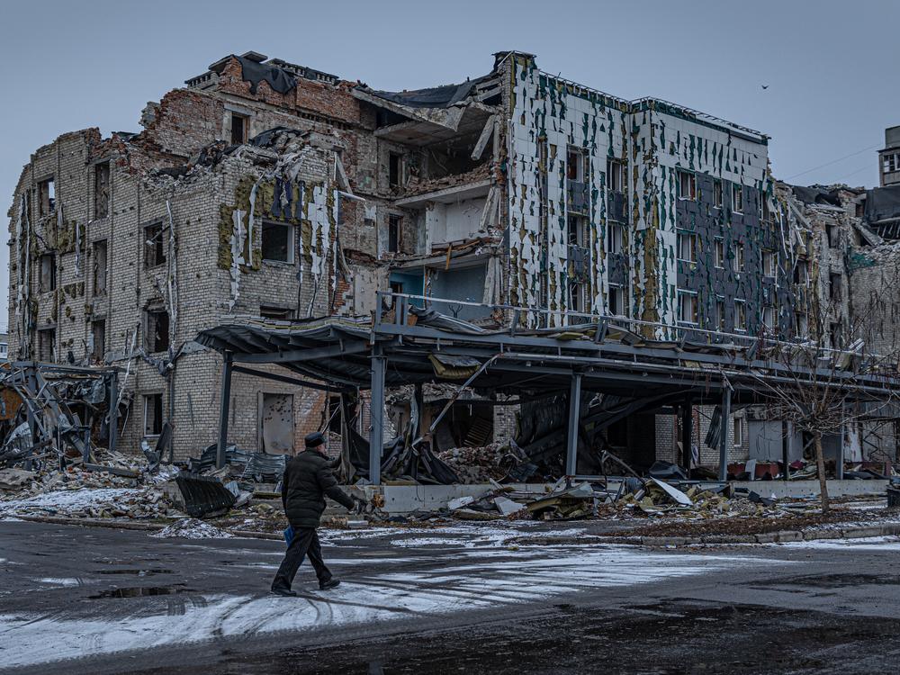 A man walks down a war-ravaged street in Pokrovsk, an industrial city in eastern Ukraine's Donetsk region, on Dec. 19, 2024. Behind him is the hotel Druzhba, which was destroyed by a Russian missile last summer. Pokrovsk was once home to 60,000 people. Now it's largely abandoned, with Russian troops active within a mile of the outskirts.