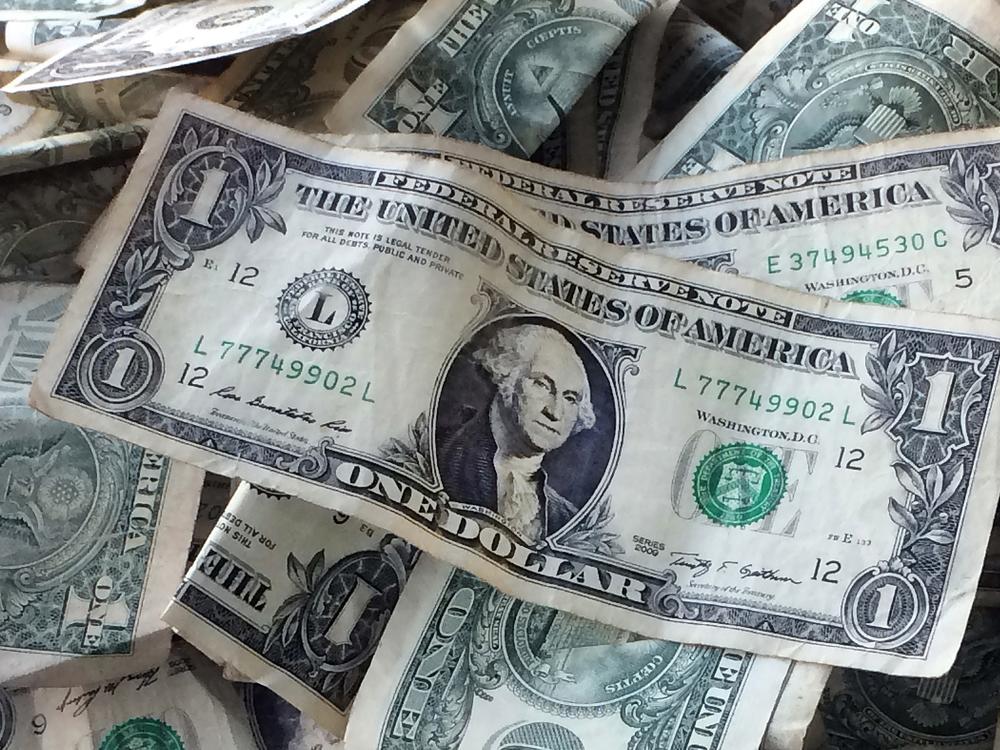 Dollar bills are shown in New York. The Economic Policy Institute says the Jan. 1 minimum wage increases show that the 