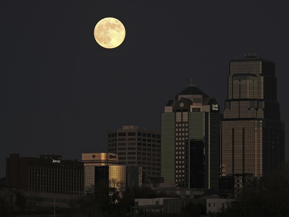The supermoon rises beyond the downtown buildings Friday, Nov. 15, 2024, in Kansas City, Mo.