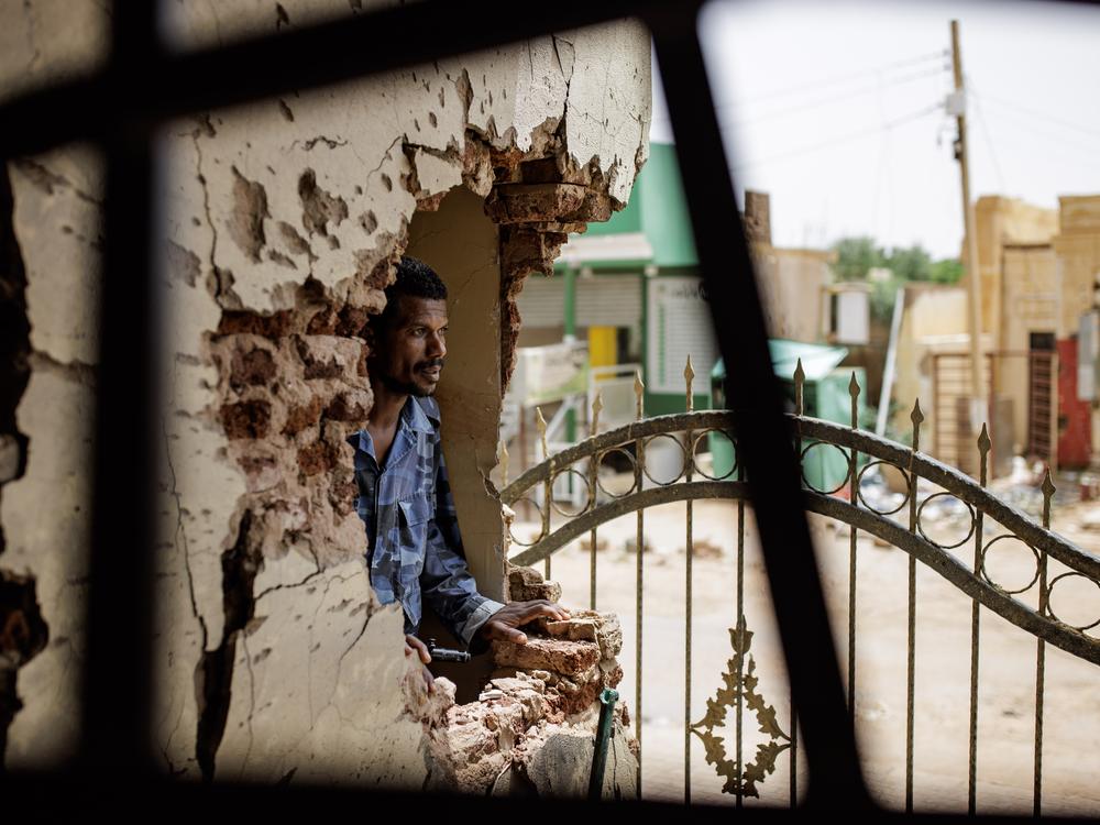 A police officer looks through damage caused by a shell at the Omdurman Maternity Hospital in Omdurman, Sudan, on Sept. 7.