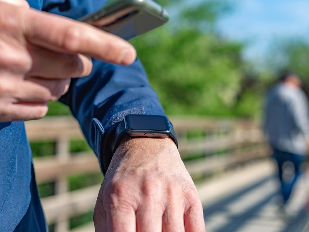 Madrid, Spain. Mature man using technology for his daily routines. For example, counting the steps he takes each day.