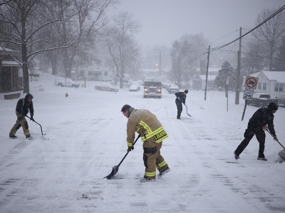 Firefighters with Louisville Fire Department Quint 9 shovel snow in front of their station on January 5, 2025 in Louisville, Kentucky. Local forecasts called for heavy snowfall followed by significant accumulation of freezing rain and ice.