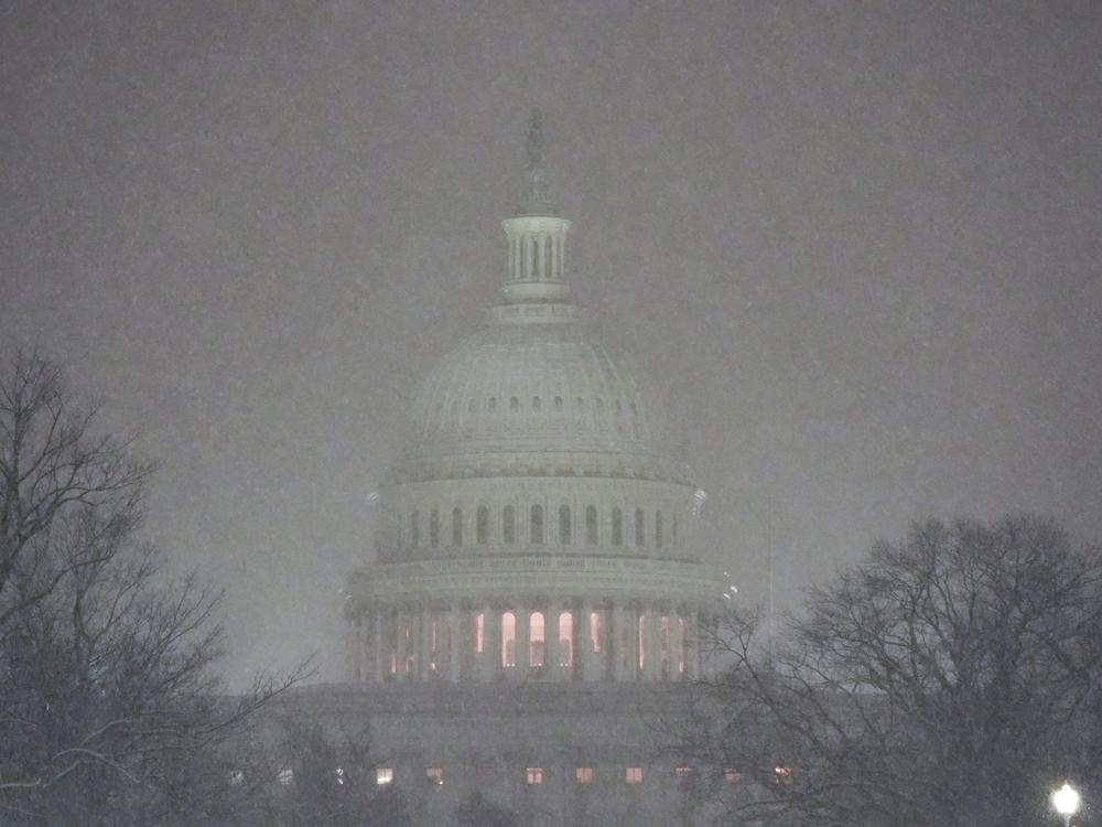 The Capitol is pictured as snow falls ahead of a joint session of Congress to certify the votes from the Electoral College in the presidential election in Washington, D.C.