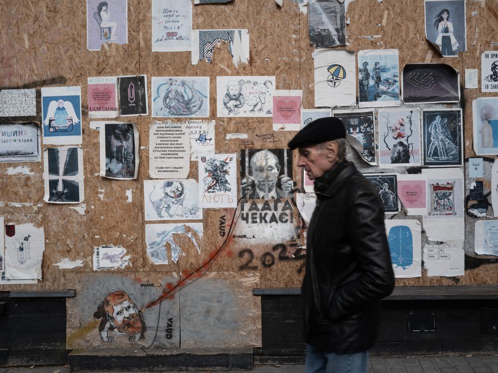 A man passes a boarded-up building covered in anti-Russia posters in Odesa, Ukraine, on Oct. 27, 2024. Anti-Russian sentiment runs high throughout Ukraine, but it runs up against a rich Russian cultural tradition in Odesa. The historical city was once a huge draw for Russian tourists, especially during the Soviet era. Russian is still spoken widely, but Ukrainians are making a concerted effort to erase the Russian legacy of the region.