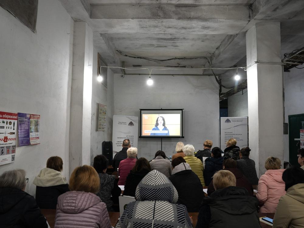 Ukrainians are gathered to write down every word they hear during an annual national dictation event, in a bomb shelter below the Odesa National Scientific Library in Odesa, Ukraine, on Oct. 28, 2024.