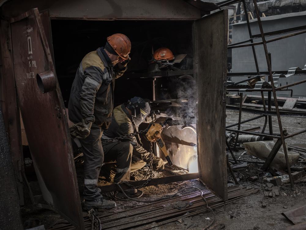 After rocket strikes, workers at a Ukrainian thermal power plant repair the facility to restore power as temperatures drop, Oct. 4. <a href=