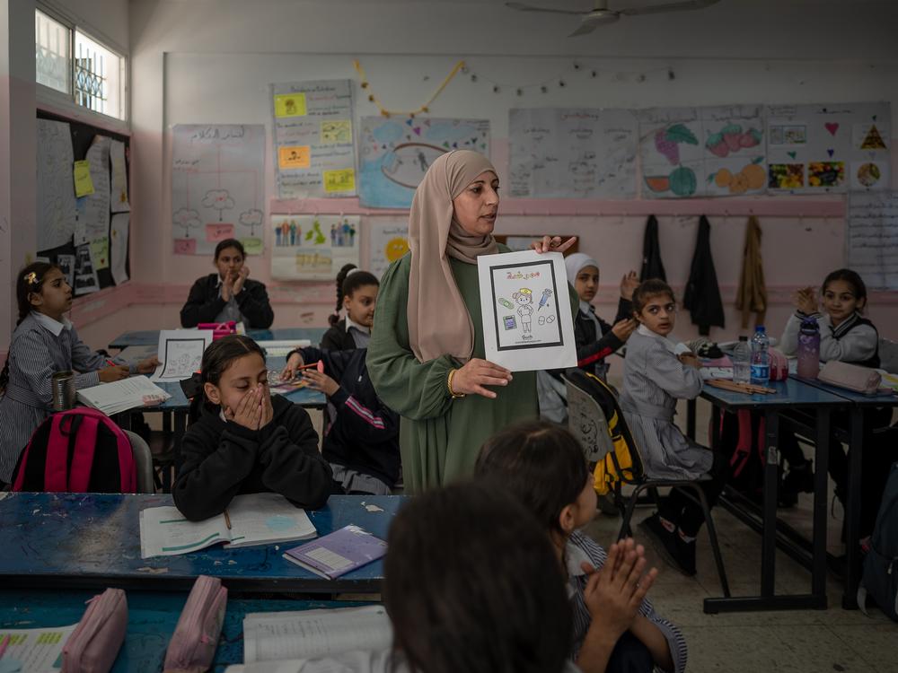 A teacher leads a class at a school for girls administered but the main U.N. agency for Palestinian aid, UNRWA, in Qalandia refugee camp, near Ramallah, in the West Bank, on Nov. 14. <a href=