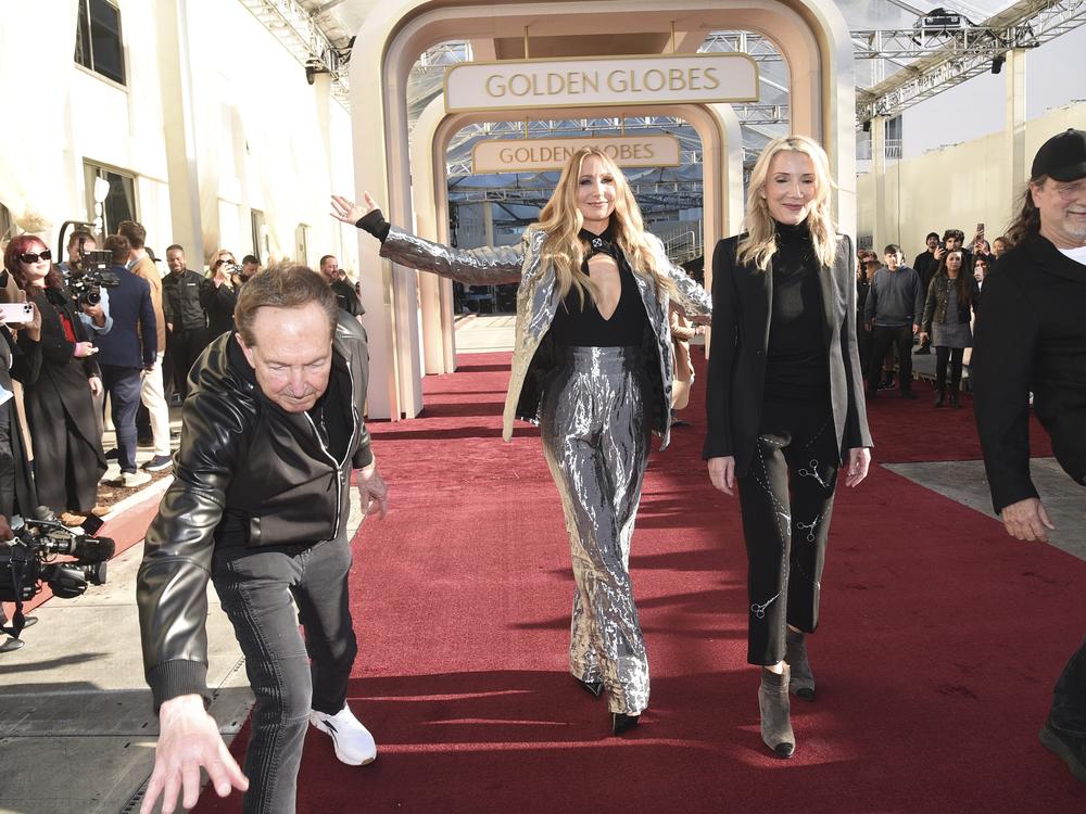 Barry Adelman, from left, Nikki Glaser, Helen Hoehne, and Glenn Weiss roll out the red carpet during the 82nd Golden Globes press preview on Thursday, Jan. 2, 2025, at the Beverly Hilton in Beverly Hills, Calif.