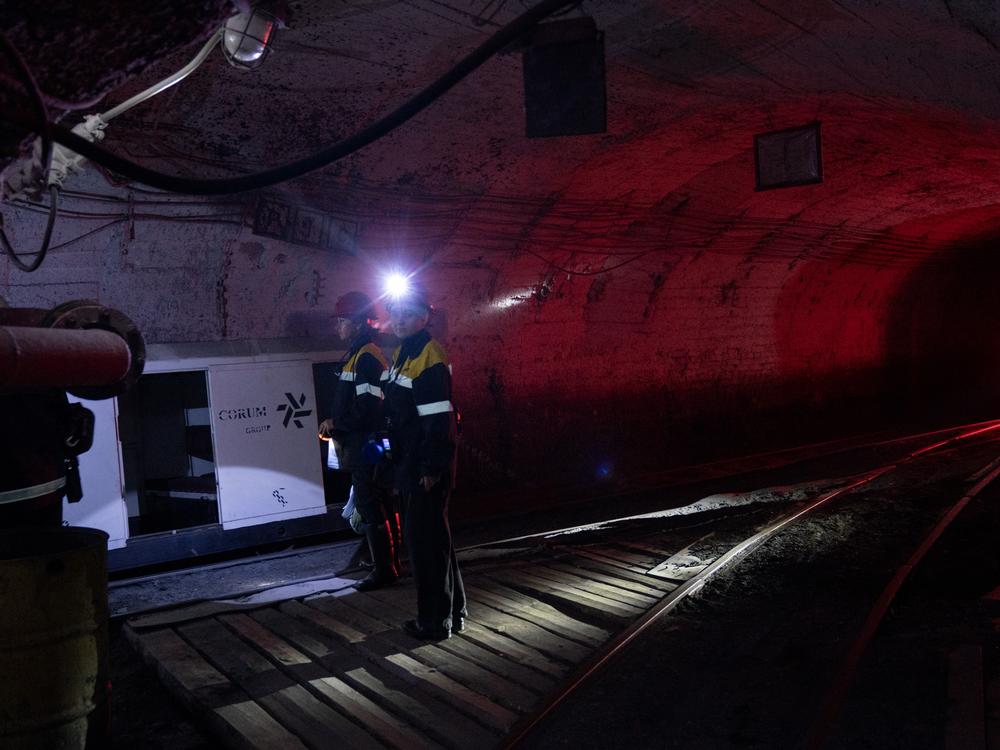 Tetiana Medvedenko and Iryna Ostanko prepare to board a small train inside the mine that will take them to their work stations. Before Russia's 2022 invasion, no women worked in underground mines in Ukraine. Now they comprise 5% of private energy supplier DTEK's workforce.