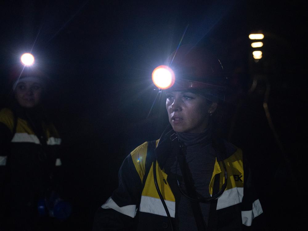 Iryna Ostanko (left) and Tetiana Medvedenko (right) stand in a tunnel 870 feet below the surface in a coal mine in Ternivka, Ukraine. 