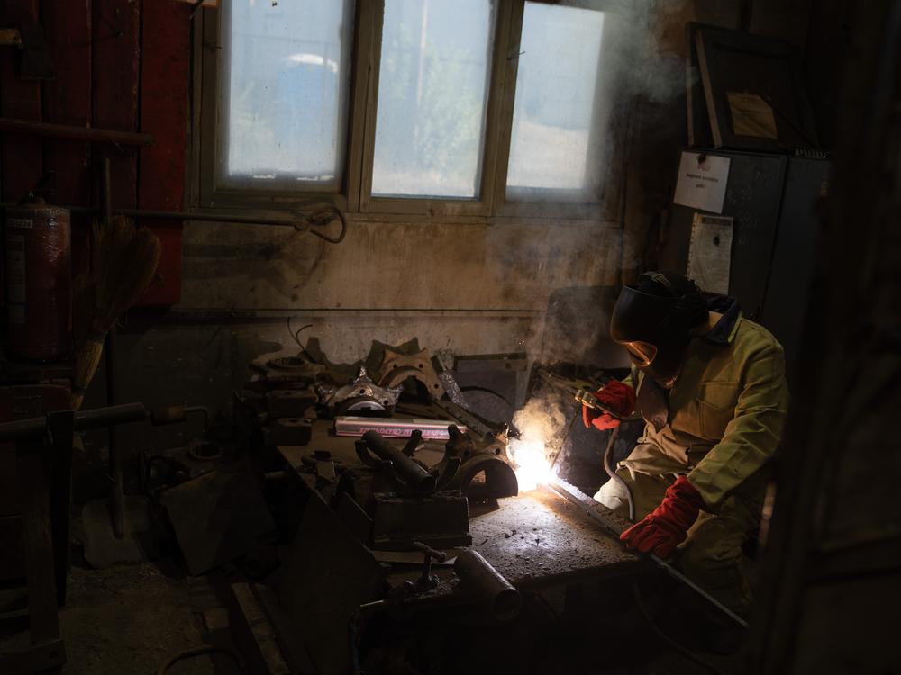 Valentina Riabova welds at a repair shop on the mine's surface, where women have been allowed to work for years. In her three decades on the job, though, she says she has often been the only woman.