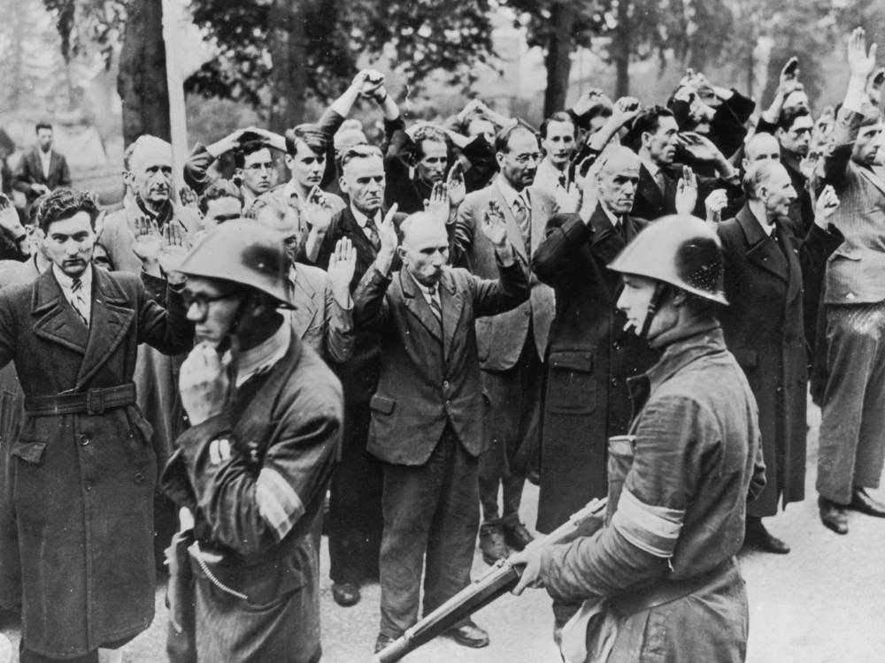 Armed Dutch patriots round up fellow townspeople accused of collaborating with the Nazis in Nijmegen in October 1944.