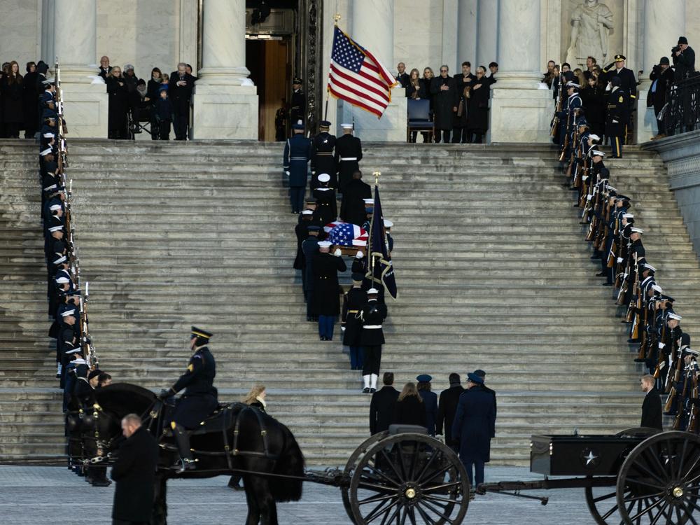 The flag-draped casket of former President Jimmy Carter travels in a horse-drawn caisson to the U.S. Capitol to lie in state in Washington, D.C., on Jan. 7.