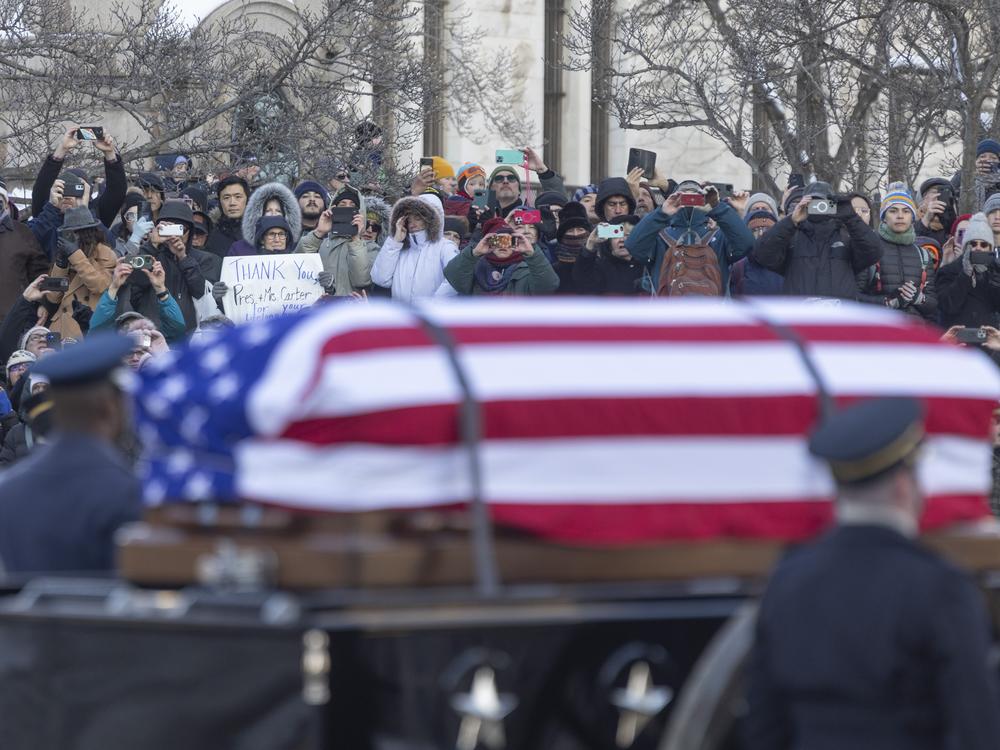 Hundreds of people lined Pennsylvania Ave as the casket of former President Jimmy Carter headed towards the Capitol where he will lie in state.