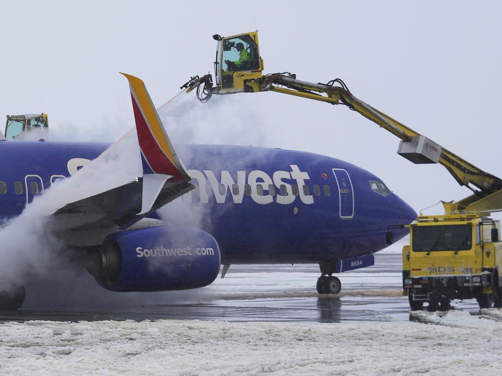 A Southwest Airlines Boeing 737 is de-iced before takeoff at Salt Lake City International Airport on Feb. 22, 2023. The wings, fuselage and tail must be de-iced before it can fly whenever there's snow, ice or frost.