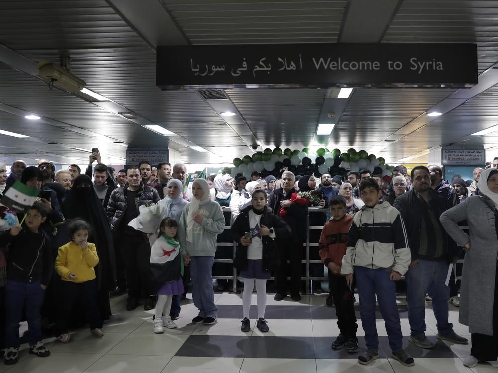 People wait to receive their relatives at the arrival terminal, after a first international commercial flight since the fall of former Syrian President Bashar Assad landed at Damascus international airport, in Damascus, Syria on Tuesday.