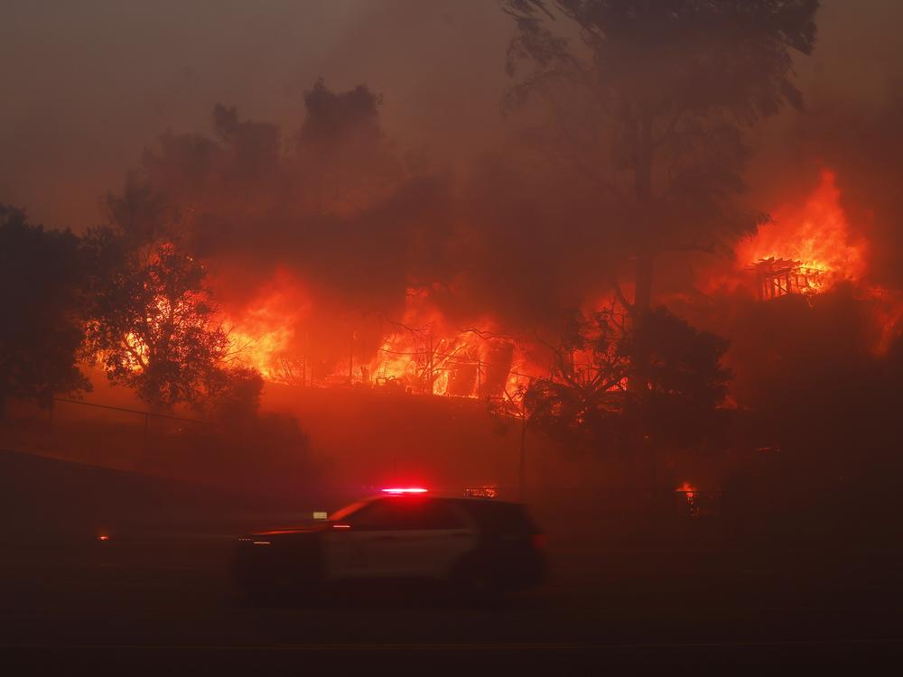 The Palisades Fire burns a property in the Pacific Palisades neighborhood of Los Angeles, Tuesday, Jan. 7, 2025. (AP Photo/Etienne Laurent)