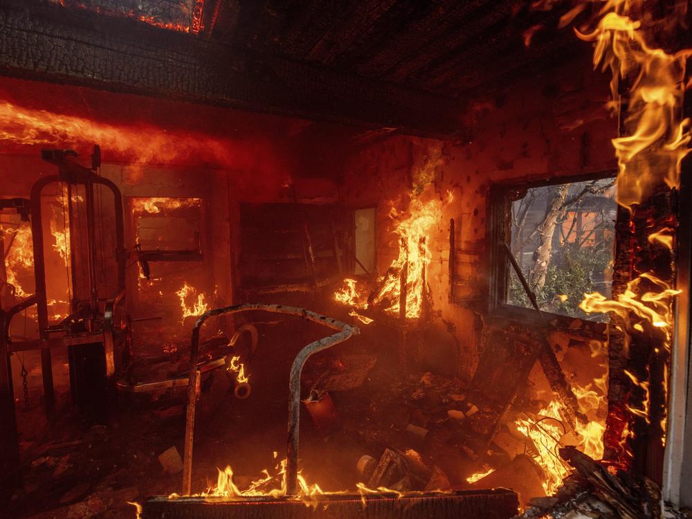 The Palisades Fire burns a residence in the Pacific Palisades neighborhood of Los Angeles.