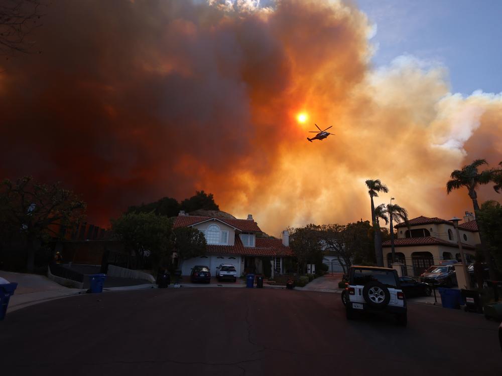 More than 200 acres (80 hectares) was burning in Pacific Palisades, a upscale spot with multi-million dollar homes in the Santa Monica Mountains, shuttering a key highway and blanketing the area with thick smoke.