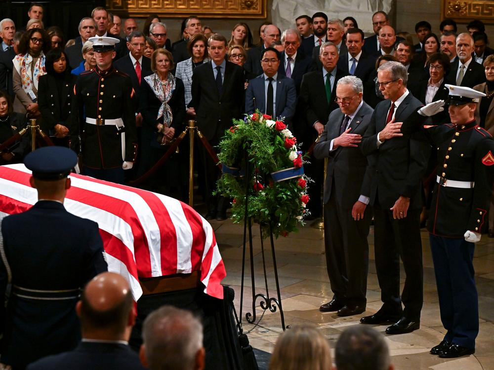 Senate Minority Leader Chuck Schumer, a Democrat from New York, left, and Senate Majority Leader John Thune, a Republican from South Dakota, pay respects at the casket of late former US President Jimmy Carter in the Rotunda of the US Capitol in Washington, D.C. on Jan. 7.