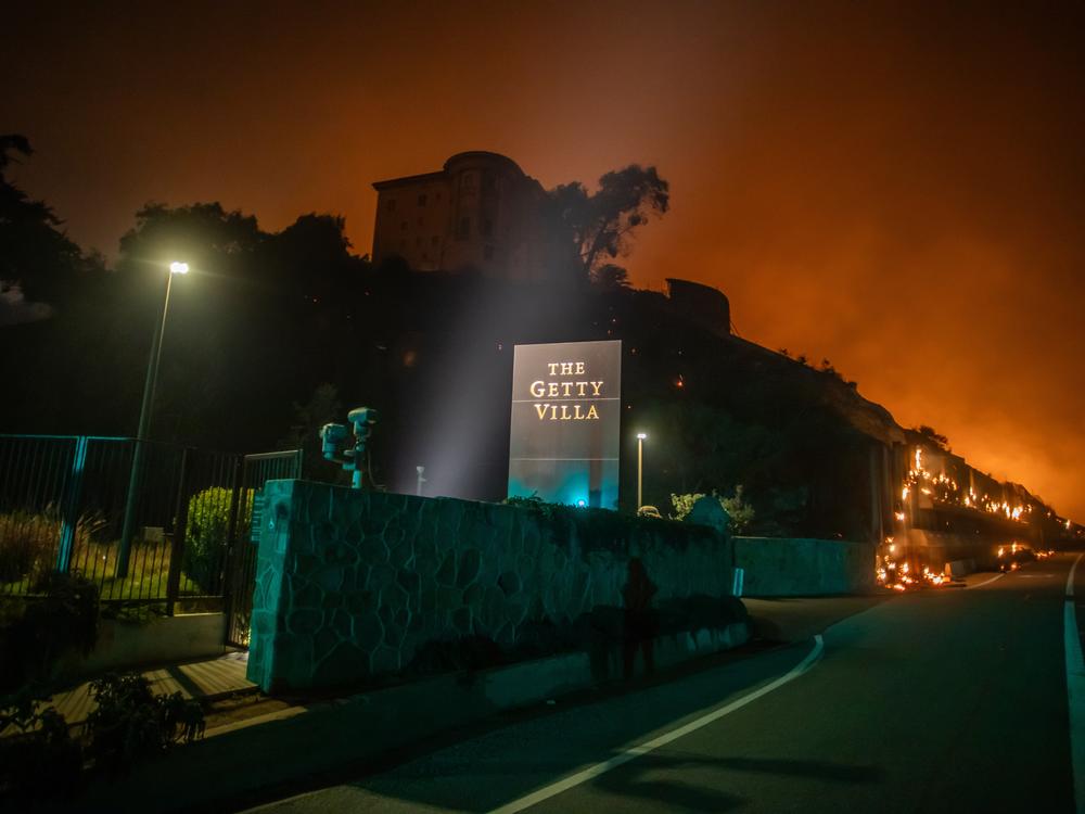 Flames from the Palisades Fire reach the grounds of the Getty Villa Museum on the Pacific Coast Highway amid a powerful windstorm on Jan. 8, 2025 in Los Angeles, Calif.