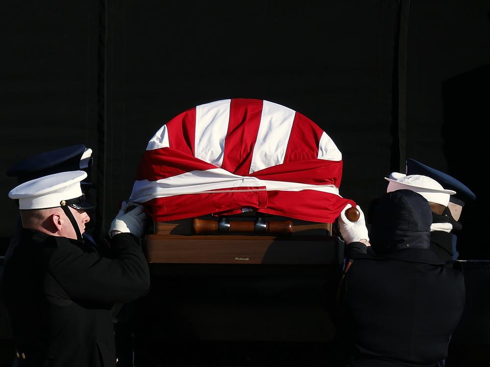 The flag-draped casket of former U.S. President Jimmy Carter is transferred to a hearse during an arrival ceremony on Jan. 7, at Joint Base Andrews, Md.