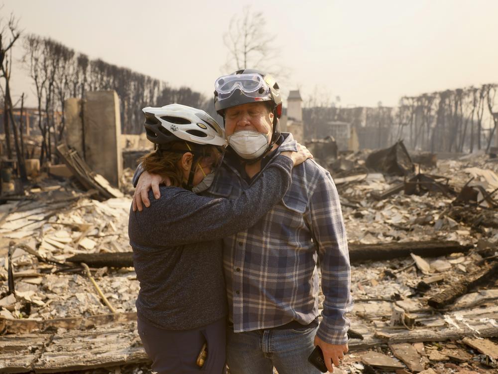 Wed., Jan 8: Claudio and Kathleen Boltiansky embrace in their fire-ravaged neighborhood.