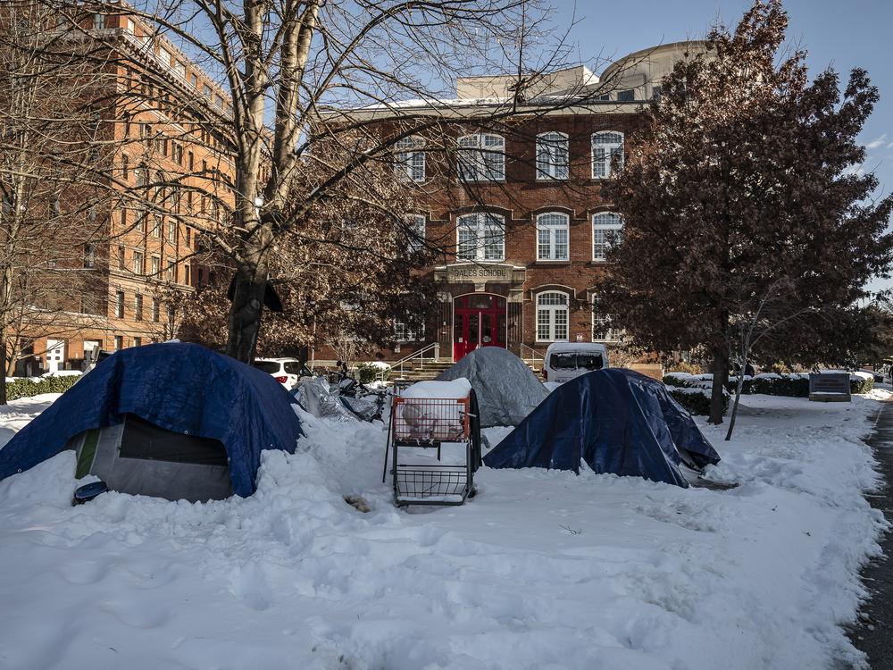 Unhoused people sleep in tents outside of Central Union Mission.