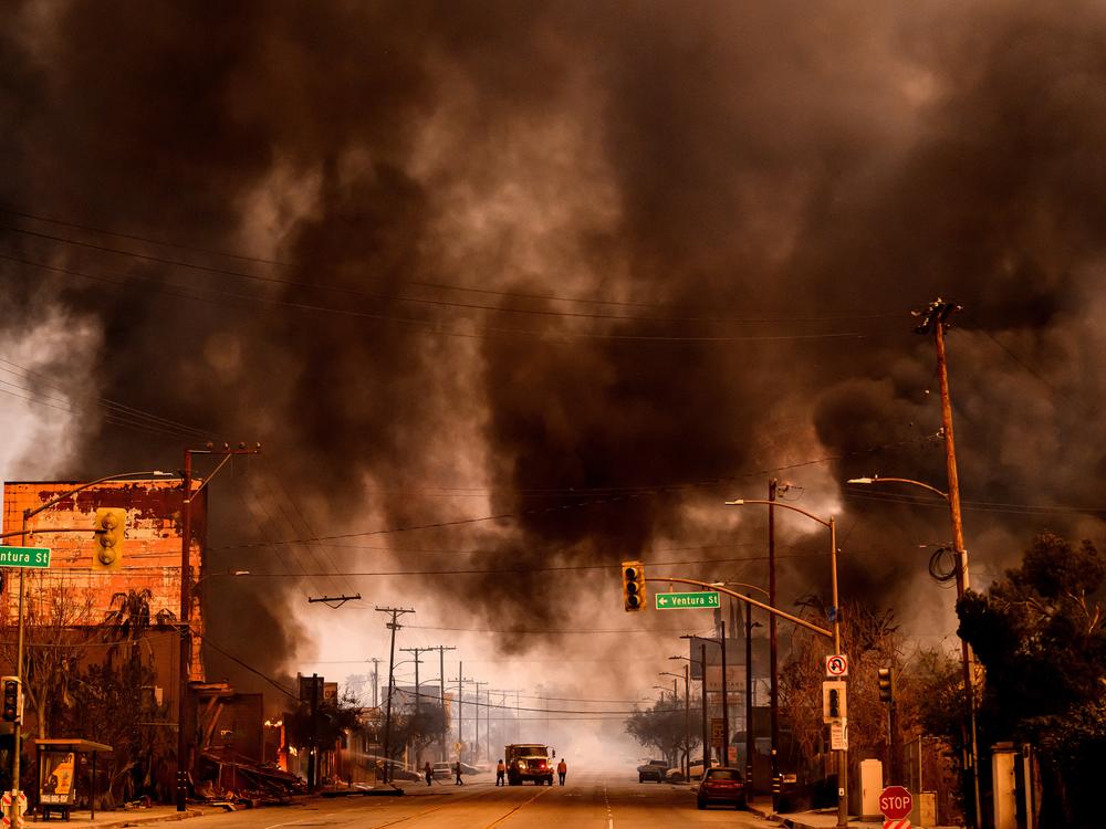 Wed., Jan. 8: Smoke and flames overwhelm a commercial area during the Eaton fire.