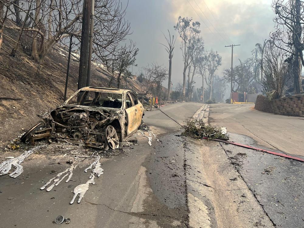 Wed., Jan. 8: A car is seen burned along the along the Pacific Coast Highway.