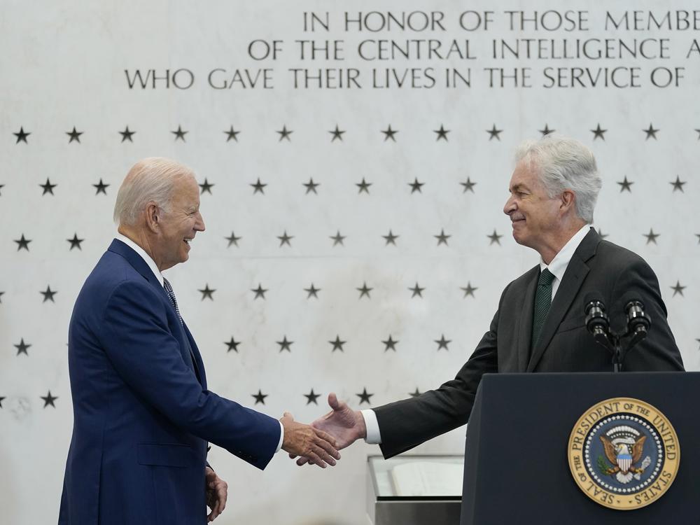 President Biden shakes hands with Central Intelligence Agency Director William Burns as he is introduced to speak at the CIA headquarters in Langley, Va., Friday, July 8, 2022.