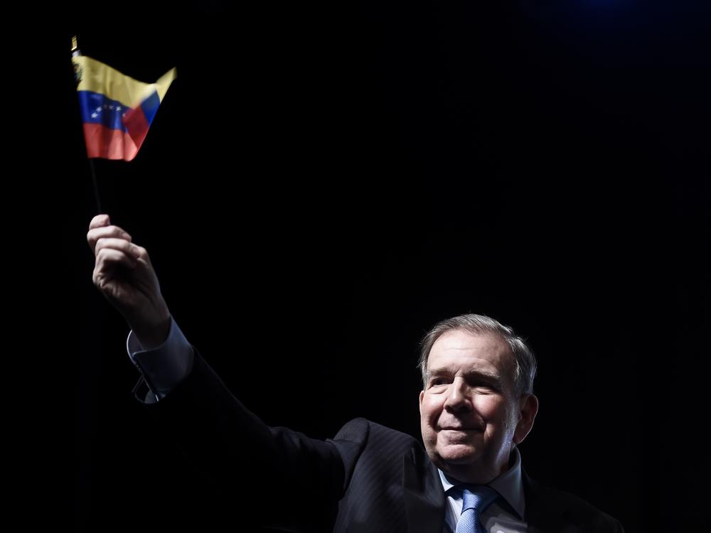 Venezuela's opposition leader Edmundo Gonzalez waves a Venezuelan flag during a meeting with supporters in Panama City, Wednesday, Jan. 8, 2025
