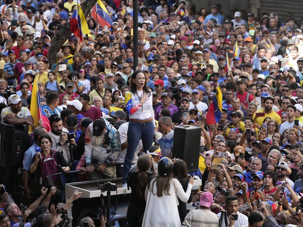 Opposition leader Maria Corina Machado stands before supporters during a protest against President Nicolas Maduro the day before his inauguration for a third term, in Caracas, Venezuela, Thursday, Jan. 9, 2025.