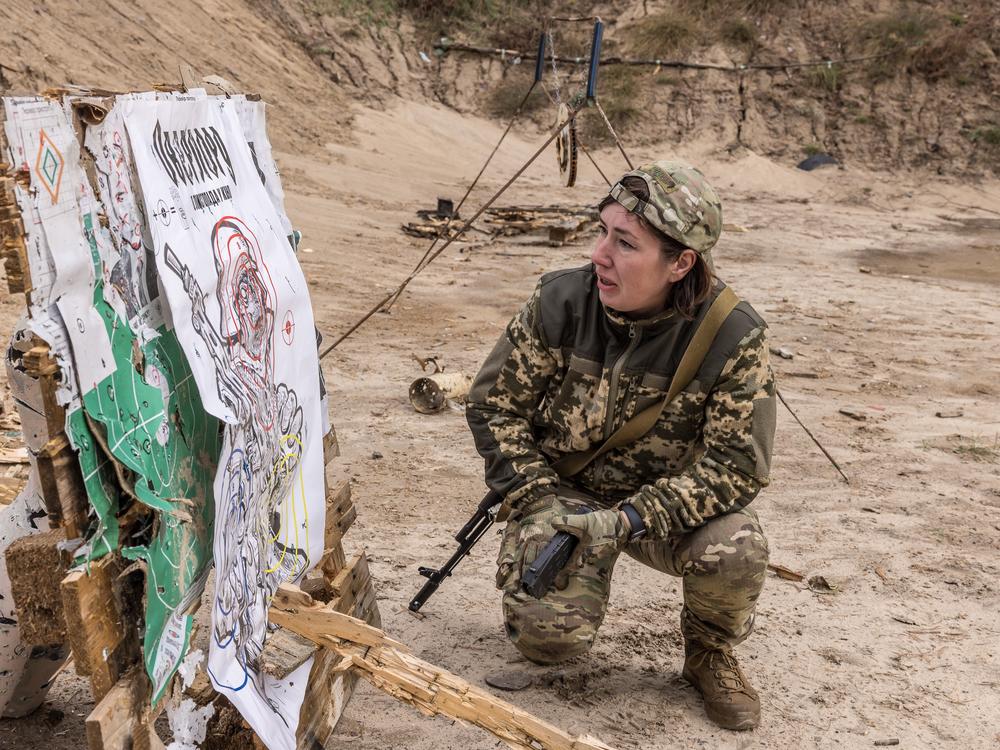 Liudmyla, a 42-year-old pastry chef, checks her shots at a shooting range outside Kyiv during training for the volunteer air defense unit known as the Combat Witches of Bucha.