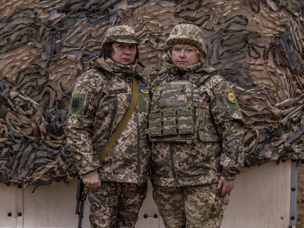 Best friends Inna (left) and Valentyna pose for a portrait during training while on duty as part of the mostly female volunteer air defense unit, the Combat Witches of Bucha. 