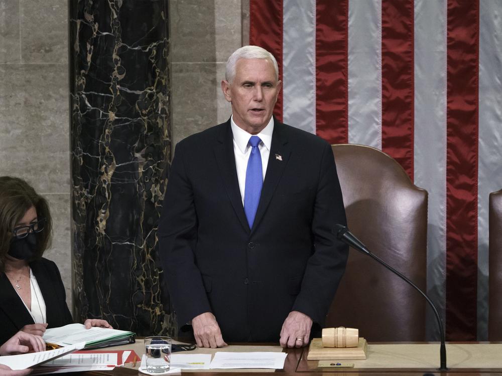 Then-Vice President Mike Pence reads the final certification of Electoral College votes after the Jan. 6 Capitol riot in 2021. A new law clarifies that the vice president's role in the counting of electoral votes is ministerial. Congress will count the votes from the 2024 presidential election on Monday.