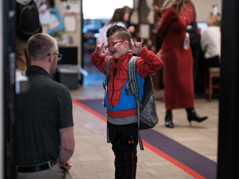 Kellen greets his teacher, Mr. Frederick, at the beginning of the school day.