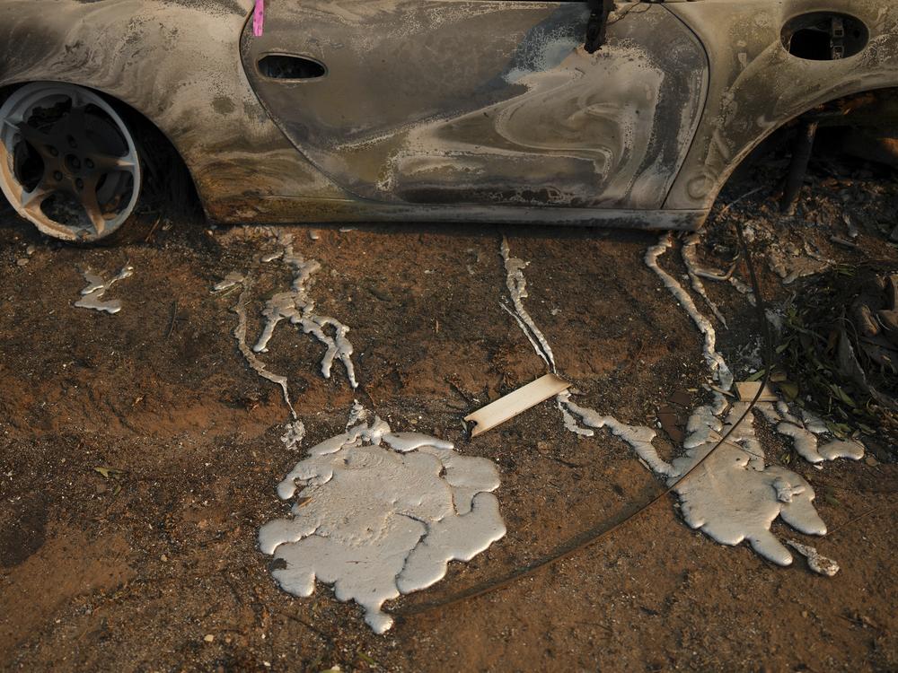Friday, Jan. 10: Melted metal from a burned vehicle is seen on the ground of a property in the Pacific Palisades neighborhood.